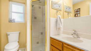 Full bath with a stall shower, vanity, and tile patterned flooring