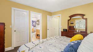 Bedroom with ensuite bathroom and carpet floors