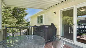 Deck with outdoor dining area and area for grilling