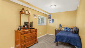 Bedroom featuring baseboards and light colored carpet