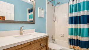 Full bath with vanity and shower / bath combo