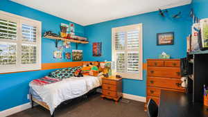 Carpeted bedroom with baseboards
