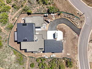 Newly constructed residence featuring a multi-gabled roofline with both dark metal and composite shingles