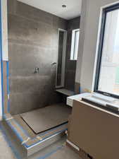 Full bath with a shower stall and vanity