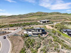 Modern architectural residence with multiple levels, featuring a stone and wood facade