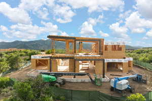 Rear view of house featuring a mountain view