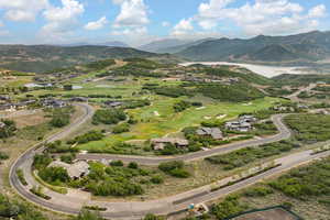 Drone / aerial view of a water and mountain view and a golf club