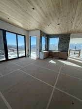Spare room with wooden ceiling and a mountain view
