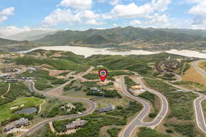 Aerial view of property's location featuring a water and mountain view