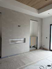 Unfurnished room with wooden ceiling and wood finished floors