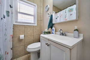Bathroom featuring vanity, a shower with curtain, and tile patterned floors