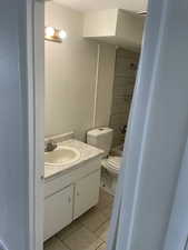 Bathroom with vanity, tile patterned flooring, bathtub / shower combination, and a textured wall