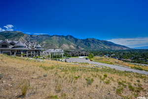 View of mountain backdrop featuring nearby suburban area