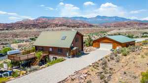 View of subject property with a mountainous background main driveway