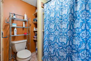 Bathroom featuring a tub shower combo and tile patterned flooring
