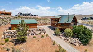 View of subject property with a mountainous background with pull through driveway new retaining wall