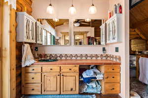 Bathroom with vanity, wood ceiling, and a ceiling fan