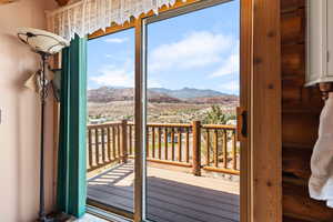 Doorway with a mountain view and healthy amount of natural light