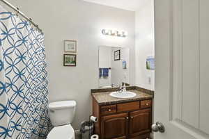 Bathroom with vanity and curtained shower
