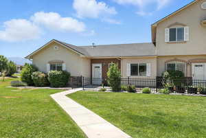 View of front of home featuring stucco siding, a shingled roof, and a mountain view