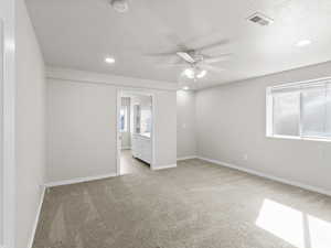 Bedroom featuring light carpet, a ceiling fan, a smoke detector, recessed lighting, and a textured ceiling
