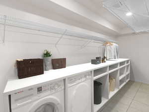 Laundry area with separate washer and dryer and light tile patterned floors