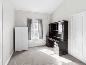 Office featuring light colored carpet and vaulted ceiling