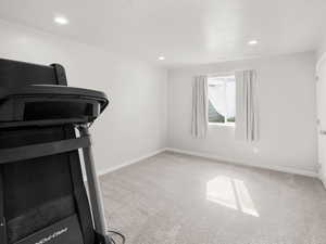Workout area with carpet flooring and recessed lighting