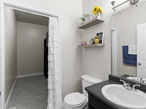 Full bathroom featuring vanity, tile patterned floors, and a shower with shower curtain