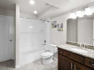 Bathroom with vanity, shower / bath combination, tile patterned floors, and recessed lighting