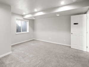 Bedroom with carpet flooring, a textured ceiling, and recessed lighting