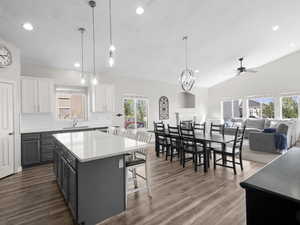 Kitchen featuring decorative backsplash, healthy amount of natural light, recessed lighting, a kitchen island, and white cabinets