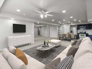 Living area with light colored carpet, recessed lighting, and a ceiling fan