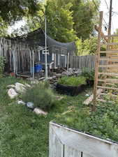 Fenced backyard featuring exterior structure and an outdoor structure
