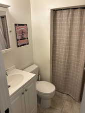 Bathroom featuring vanity, a shower with curtain, and tile patterned floors