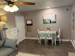 Dining area featuring ceiling fan, dark wood-style floors, and recessed lighting