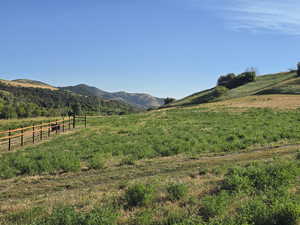 View of mountain backdrop featuring rural landscape