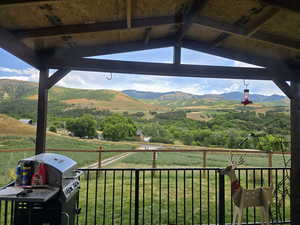 View of mountain backdrop with rural landscape and agricultural land