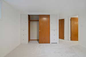 Unfurnished bedroom with carpet flooring and a closet