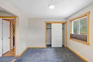 Unfurnished bedroom featuring a closet and carpet