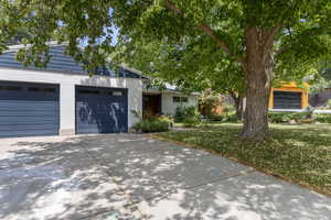 View of front of house with driveway, an attached garage, and brick siding