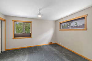 Spare room featuring carpet floors and baseboards
