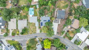 Aerial view of property and surrounding area with nearby suburban area