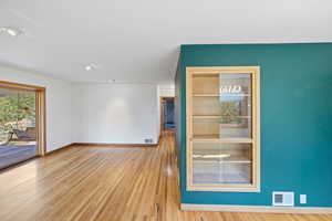 Empty room featuring wood finished floors and recessed lighting