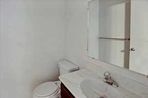 1/2 Bathroom with vanity and toilet
