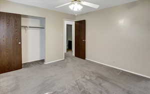 Unfurnished bedroom with carpet flooring, a closet, and ceiling fan
