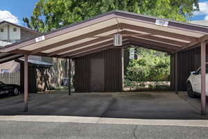 View of covered 2 car parking w/ storage shed