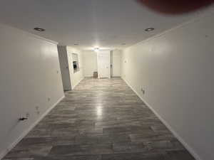 Hallway featuring ornamental molding, dark wood-style floors, and recessed lighting