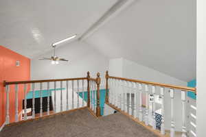 Hall featuring an upstairs landing and carpet
