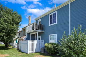 View of home's exterior with a balcony and a central AC unit